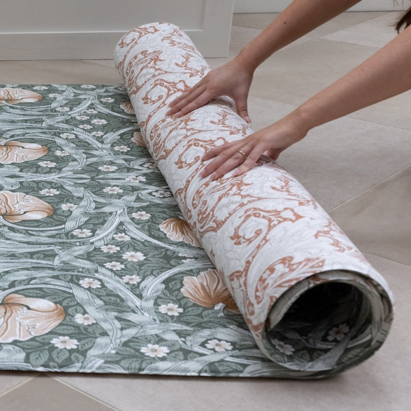 rolled green and red playmat with william morris designs