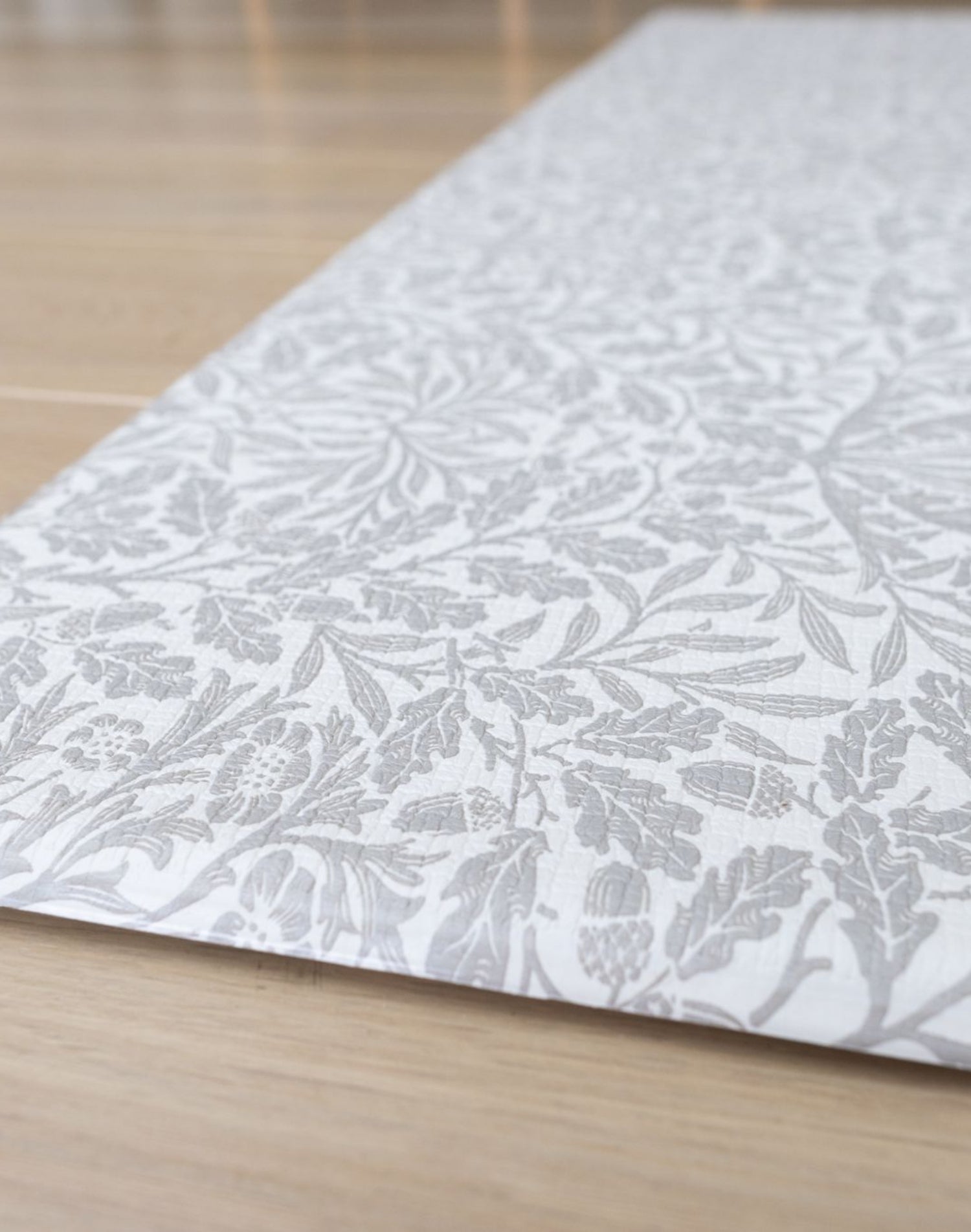 Detail of The Acorn Playmat’s floral woodland pattern - a practical yet stylish non-toxic play mat with an easy-care memory foam surface.