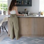 Lady standing on Kitchen runner by Totter and Tumble provides support for joints in the kitchen and can be used as an exercise with stylish design the whole family will love