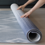 Unrolling one piece Memory foam mat in blue and beige ikat print that looks modern in family homes perfect squishy surface for the whole family