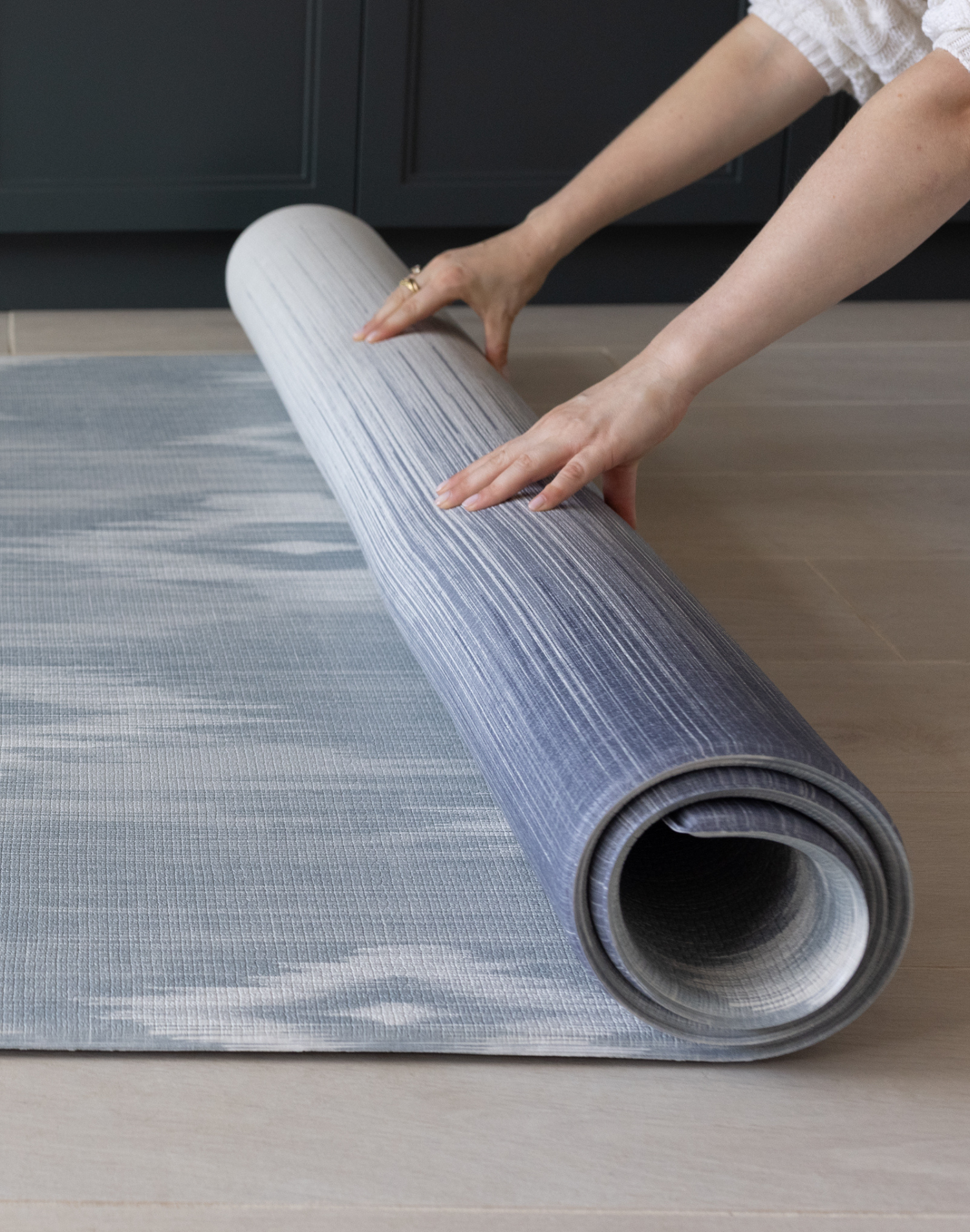 Unrolling one piece Memory foam mat in blue and beige ikat print that looks modern in family homes perfect squishy surface for the whole family