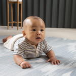 Baby tummy time on Thick padded play mats by totter and tumble are perfect for the smallest members of the family The Atlas has a hand drawn Ikat design in modern green and beige shades