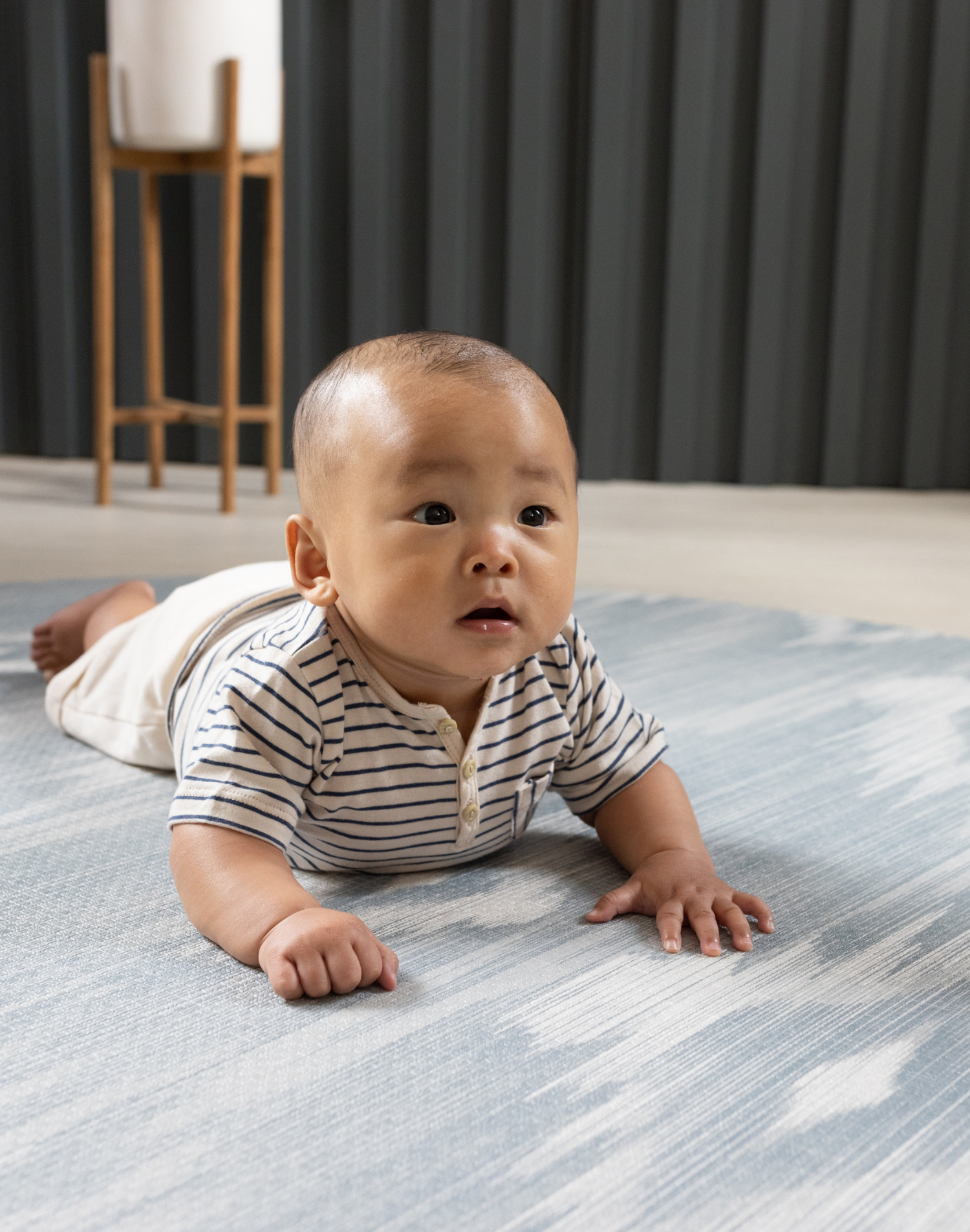 Baby tummy time on Thick padded play mats by totter and tumble are perfect for the smallest members of the family The Atlas has a hand drawn Ikat design in modern green and beige shades