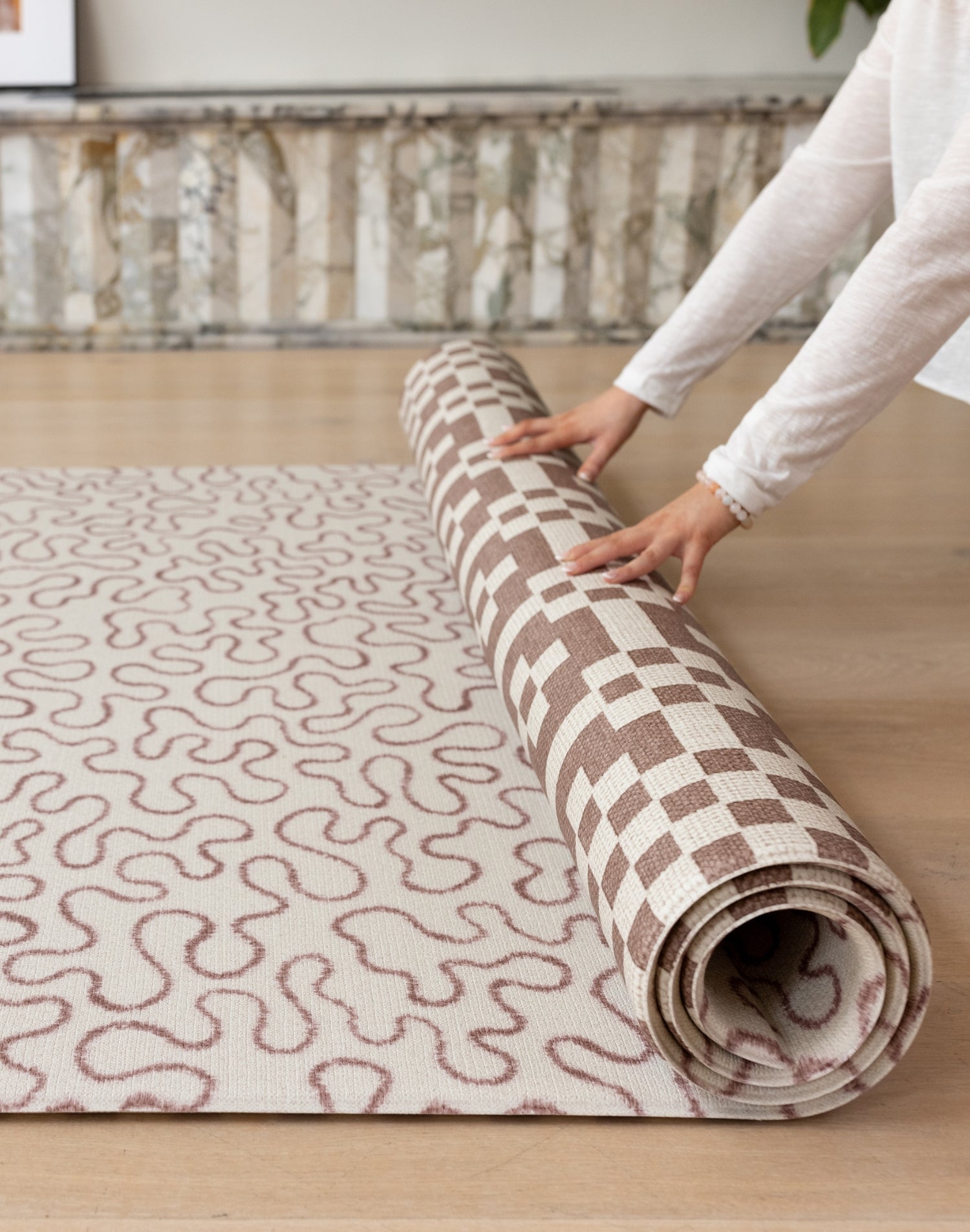 Easy to roll up The Brecon reversible playmat, a compact, wipeable baby mat in a handwoven style for modern, busy homes