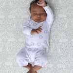 Baby relaxes on The Brer Rabbit Playmat with floral heritage prints, ideal for soft aesthetic spaces.