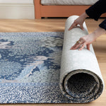 Unrolling a one-piece luxury playmat from Totter + Tumble with woodland animal and floral motifs - decorative, easy-to-clean and perfect for warm maximalist interiors.