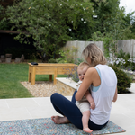 totter and tumble play runner being used outdoors with mum and baby playing together on the floor mat padded foam so you can't feel the floor underneath, non toxic and comfy play mat