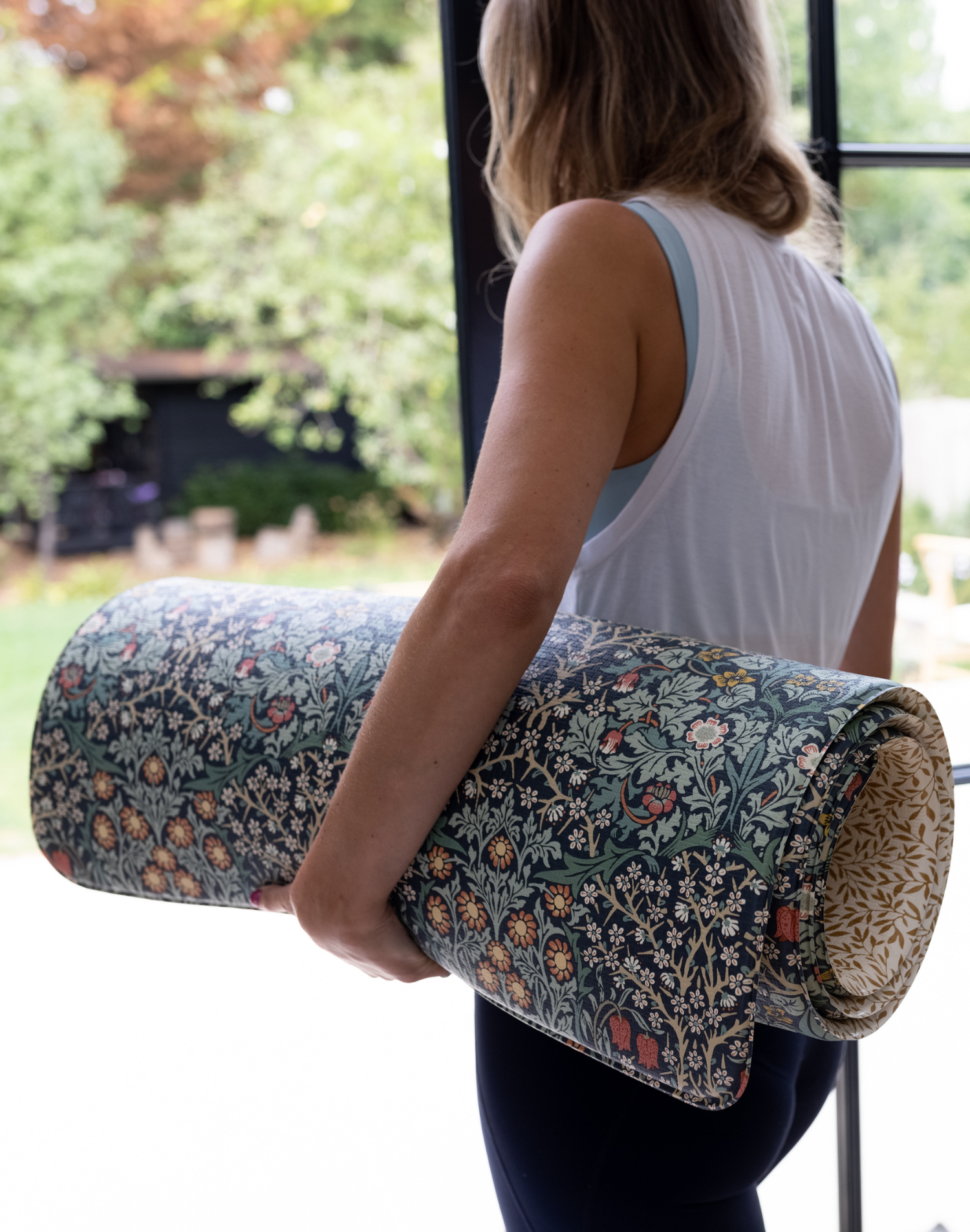 mum carrying totter + tumble playmat into garden can be used outdoors for playing or exercise mum yoga and pilates mat