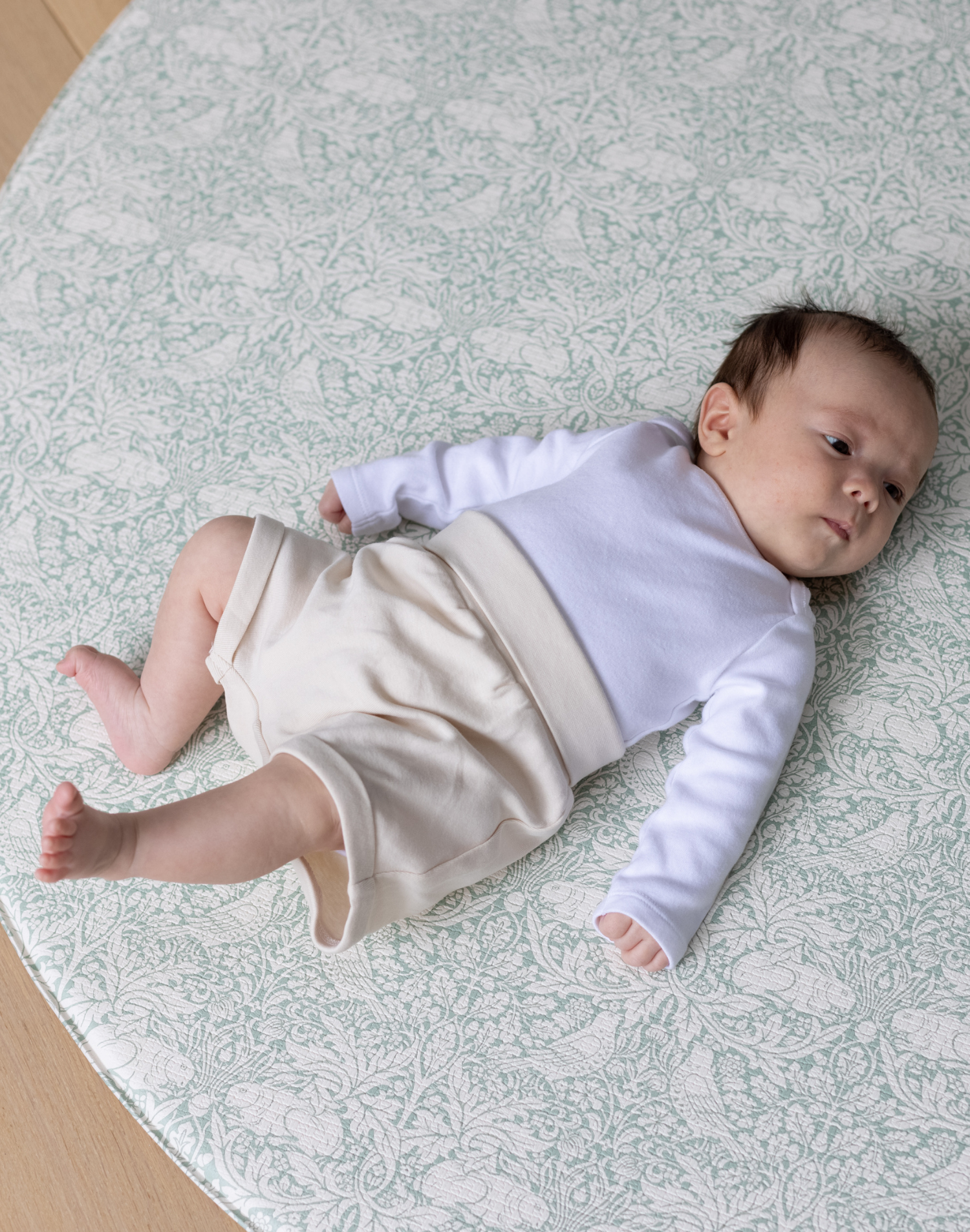 totter and tumble brer rabbit round playmat with baby relaxing on padded foam playmat for toddlers, best baby playmat rug comfy for tummy time and wipeable playmat for any spills or dribbles