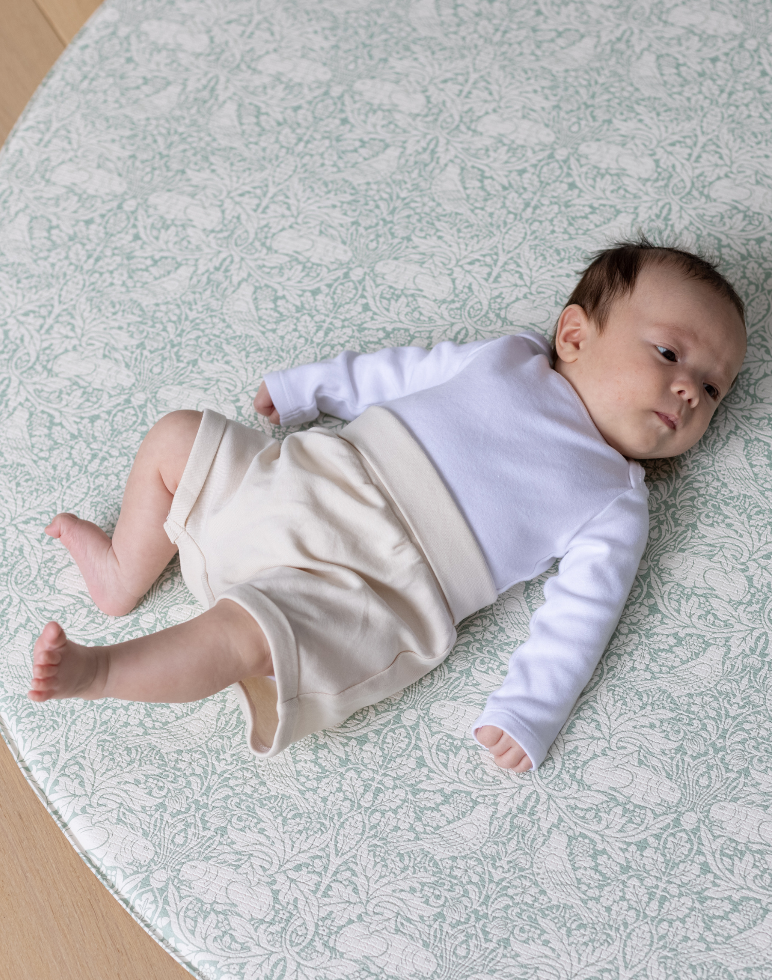totter and tumble brer rabbit round playmat with baby relaxing on padded foam playmat for toddlers, best baby playmat rug comfy for tummy time and wipeable playmat for any spills or dribbles