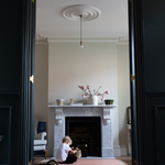 Boy plays with basket in living room sitting comfortably on durable playmat that complements modern styling