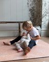 Brothers play on the terracotta tumble rug  by totter and tumble with a thick design to protect tumbles