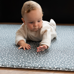 Baby tummy time on baby activity mat with a luxury padded memory foam design