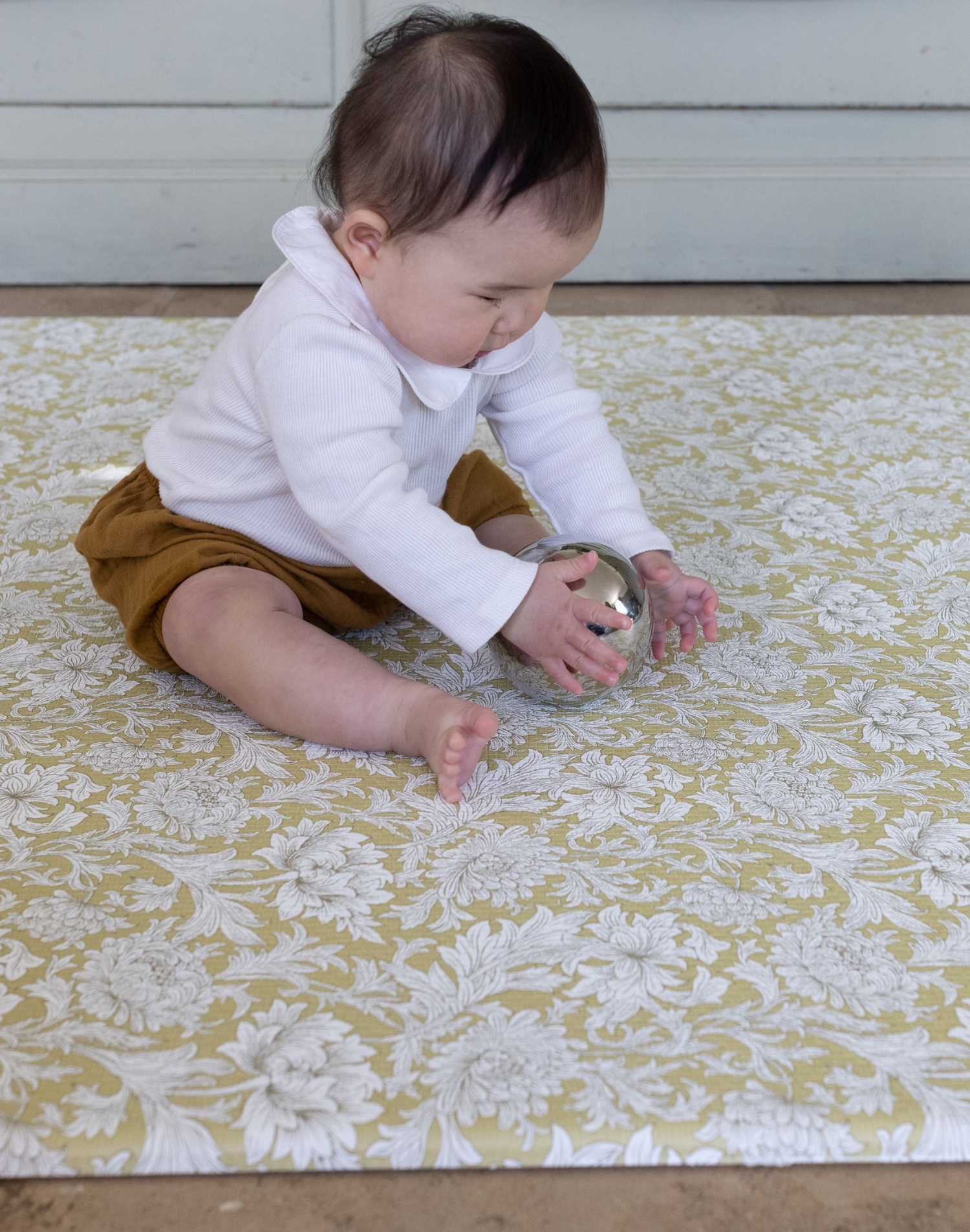 baby playing on play mat rug. morris & co playmats like totter and tumble are wipeable, easy to clean foam play mat padded to protect your little one from tumbling and the floor underneath.