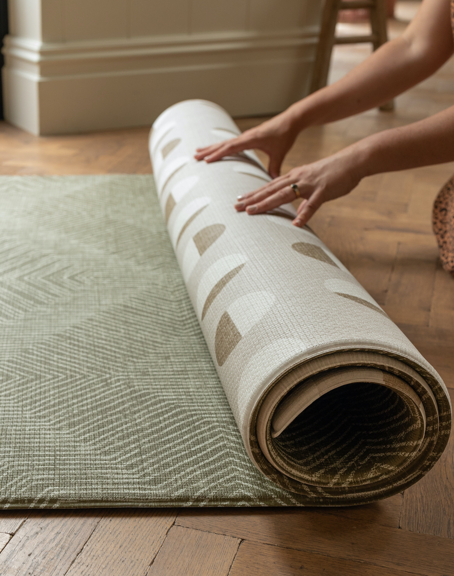 Unrolling thick one piece play mat with dual designs for more choice on one side a green kilim pattern has a rug aesthetic the reverse includes a stylish polka pattern