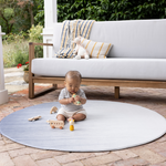 Baby sitting up on foam mat by totter and tumble in large round size ideal for unrolling on the patio in the warm weather for protection on the floor