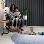 Mother and children sitting comfortably on Baby play mat safe in large round size so there is more space to play stylish blue design complements modern homes
