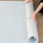 Unrolling modern one piece playmat with reversible designs created for modern family homes with a scalloped wave and vintage inspired chevron