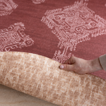 Hand folds back edge of reversible memory foam playmat with two stylish motifs created for modern family interiors