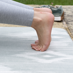 Thick memory foam and a textured surface provides support and traction for lady exercising on totter and tumble runner play mat