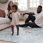 Mother father and baby enjoy floor time on Simple baby play mat in stylish ikat design perfect for family homes in subtle green and grey design