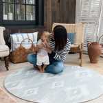 Mother and baby enjoying large round play mat made with thick foam and safe materials