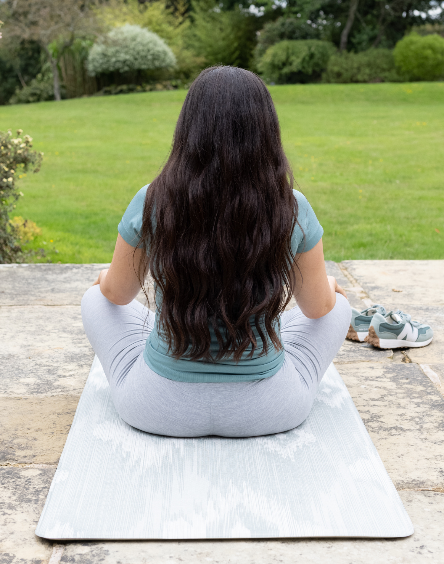 Lady exercises on foam runner on the patio ideal as a standing mat in the home and also for play it provides support with thick memory foam