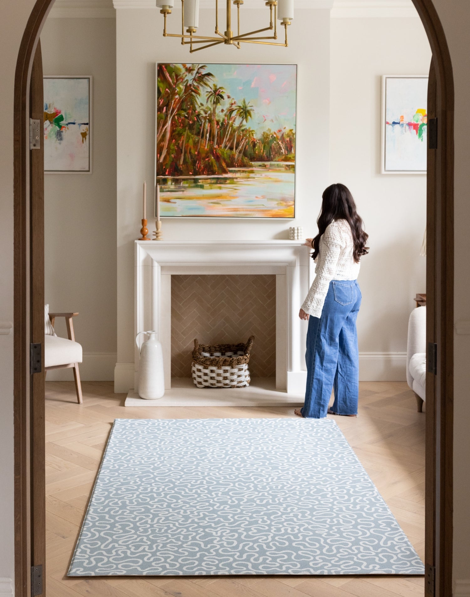 The Pembroke handwoven style playmat styled in a modern living space, a UK-designed baby mat in soft blue.