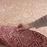 Hand pulls back edge of double sided memory foam playmat The Rusa and The Merah thick memory foam allows for comfort in the family homes with two motifs to complement modern home interiors