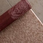 Close up of the animal print playmat The Rusa with the deep red Merah design on the reverse a versatile and stylish playmat combination for modern family homes