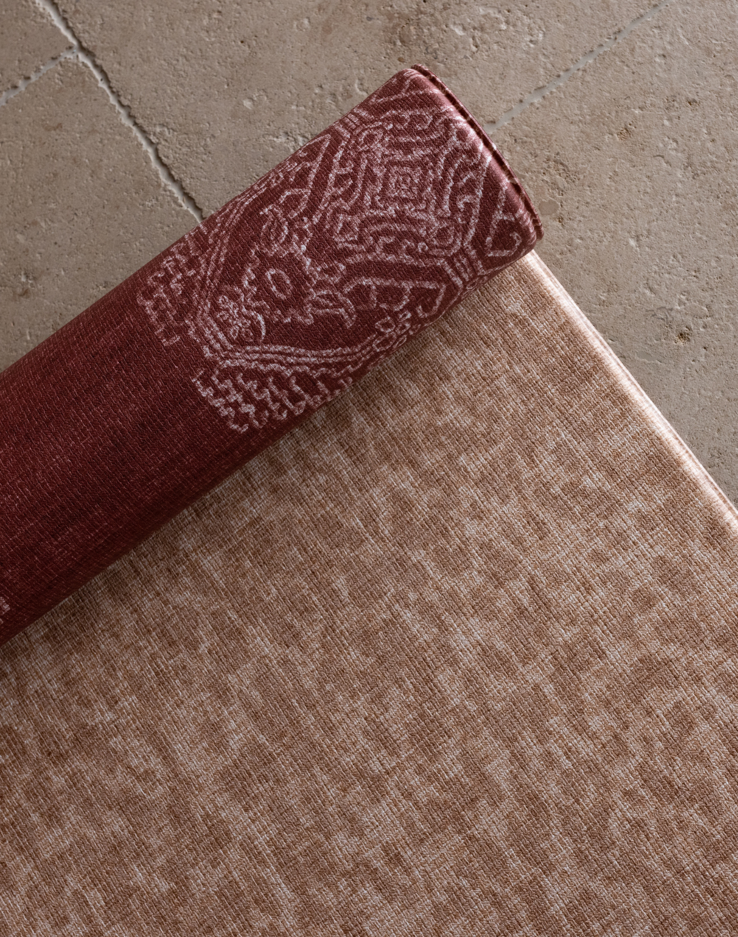 Close up of the animal print playmat The Rusa with the deep red Merah design on the reverse a versatile and stylish playmat combination for modern family homes