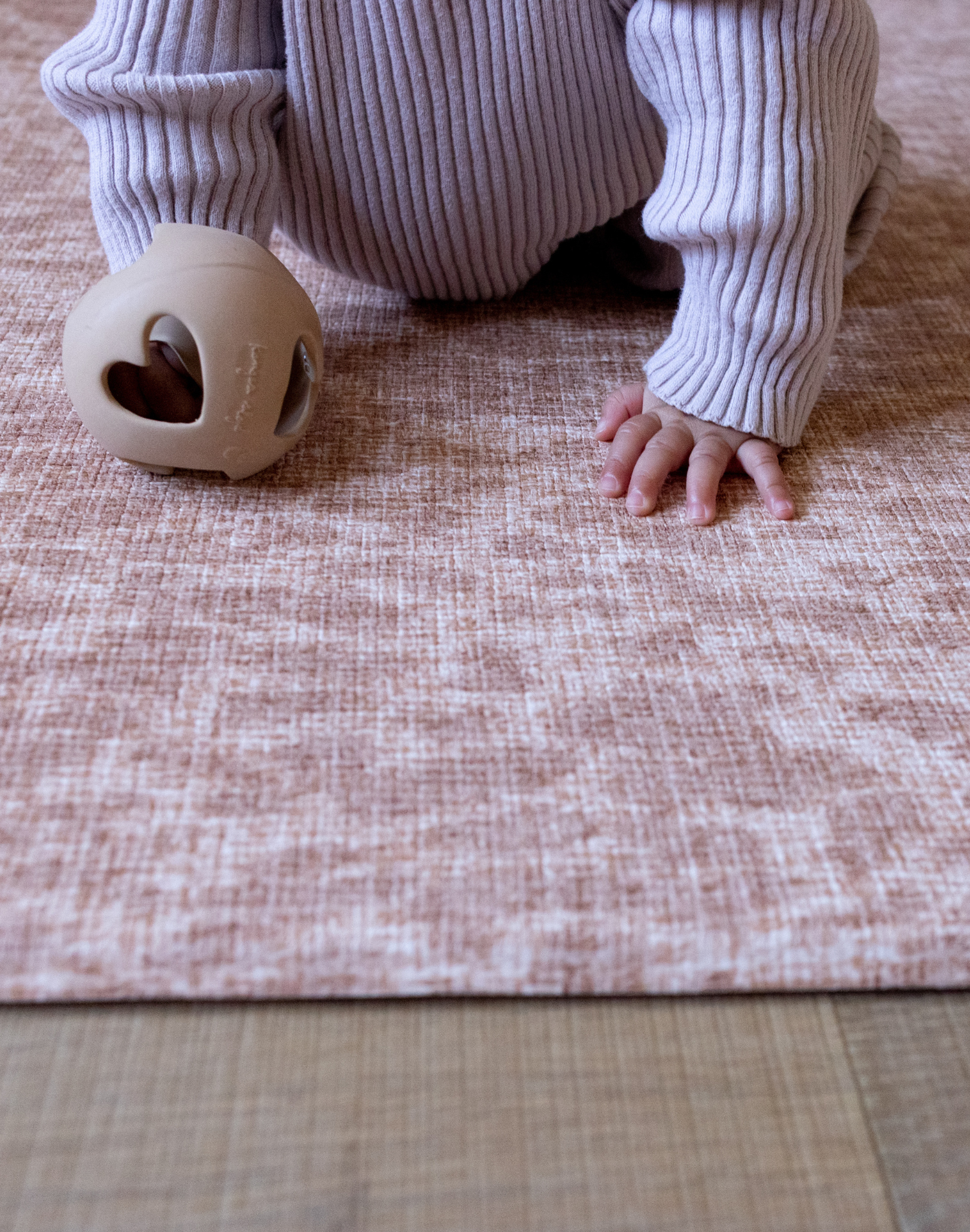 Baby hands are supported on the thick memory foam Rusa playmat allowing little ones to enjoy floortime play in comfort