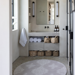 Beautiful round bathroom mat with a wipeable surface and thick memory foam to keep babies comfortable during changing a Batik inspired textile design complements a modern boho interior design