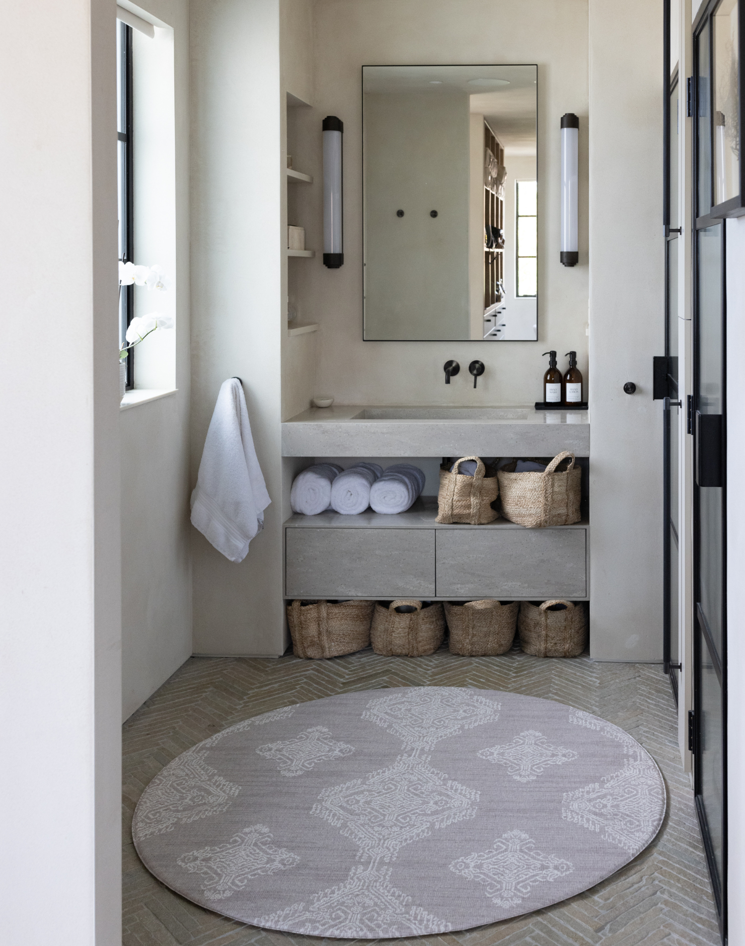 Beautiful round bathroom mat with a wipeable surface and thick memory foam to keep babies comfortable during changing a Batik inspired textile design complements a modern boho interior design