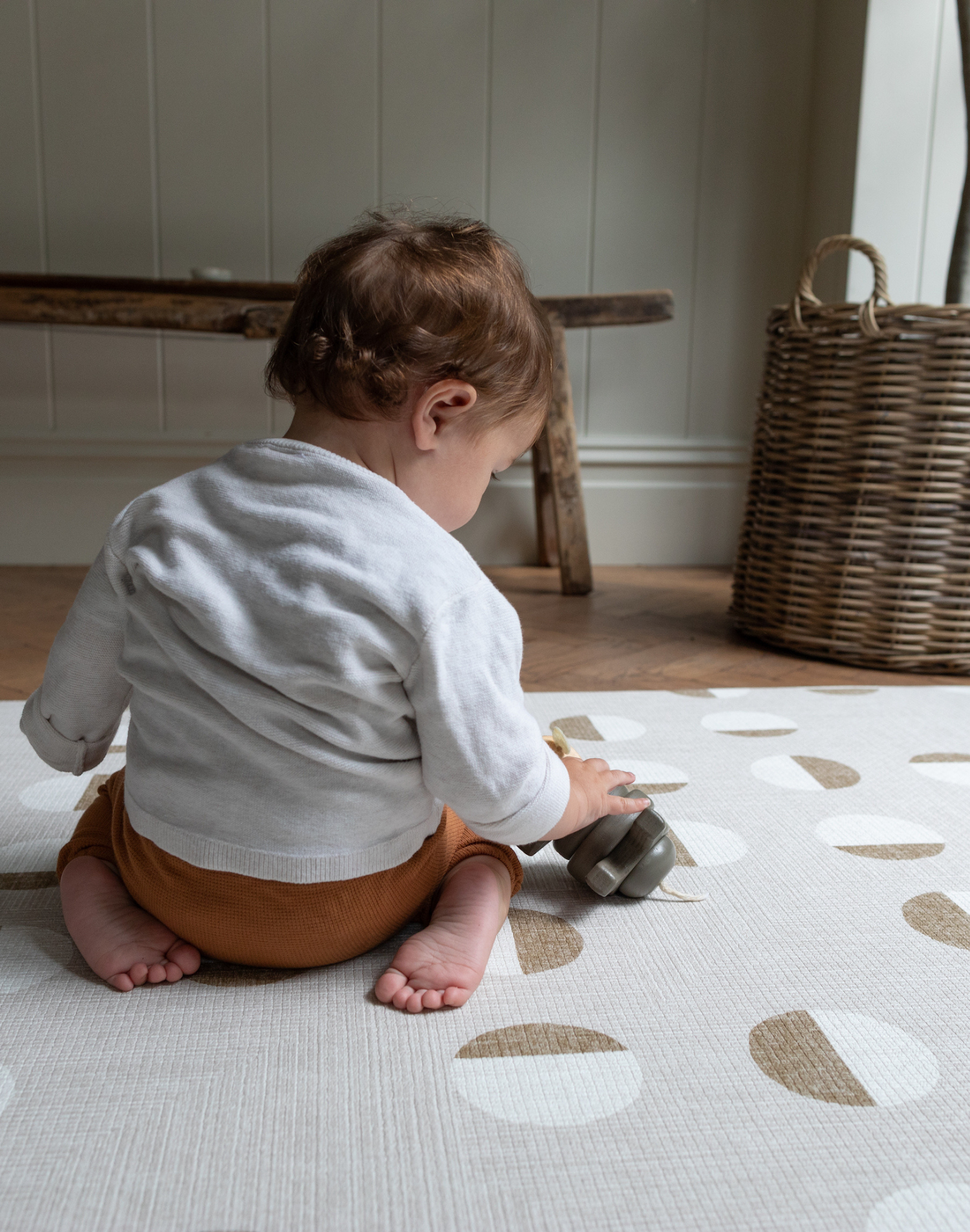 Little boy kneels on knee saving playmat with luxury memory foam for support