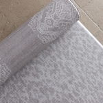 Close up of the grey animal print playmat with a textural batik inspired rug design on the rug unroll on hard wood tiled or carpeted flooring for support and comfort for the whole family