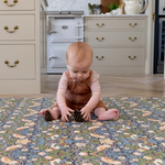 baby playing on totter and tumble padded playmat in morris & co strawberry thief designed for family life one piece, wipedown easy clean play mats alternative to rug