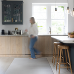 Lady walks across Foam mat made with quality materials and featuring neutral tan and beige design
