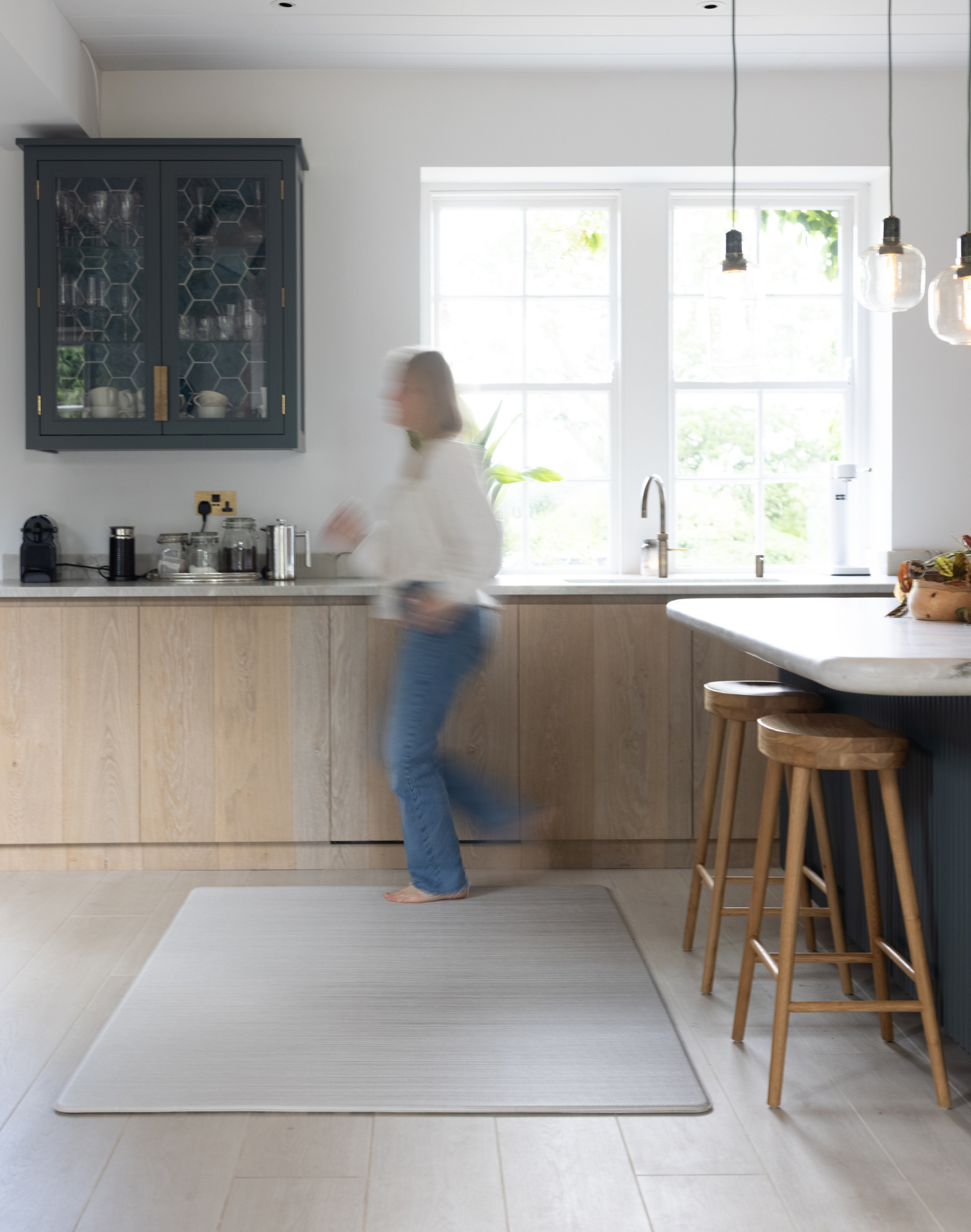 Lady walks across Foam mat made with quality materials and featuring neutral tan and beige design