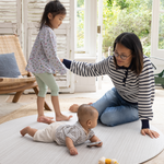 Mother enjoys floor play with baby and toddler on Beige baby play mat made with memory foam and a beautiful gradient motif