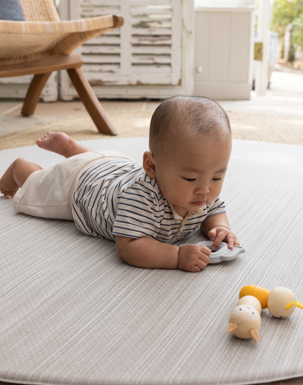 Tummy time on Beautiful baby play mat made from thick memory foam for supportive floor play with tan and beige stylish design