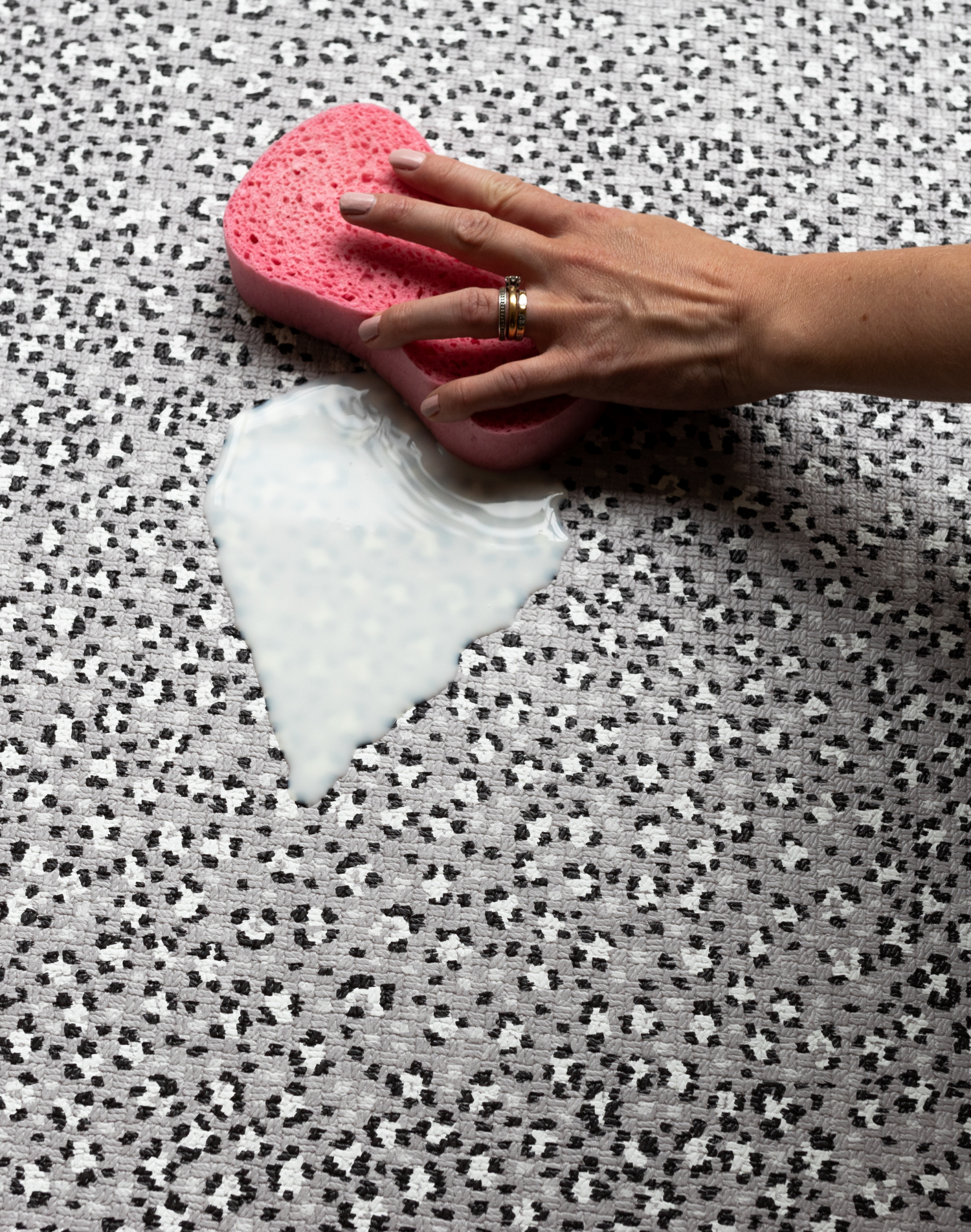 Wiping up milk spillage with sponge on wipeable playmat by totter and tumble