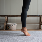 Legs are supported during exercise on the exercise mat by totter and tumble with grey leopard print design