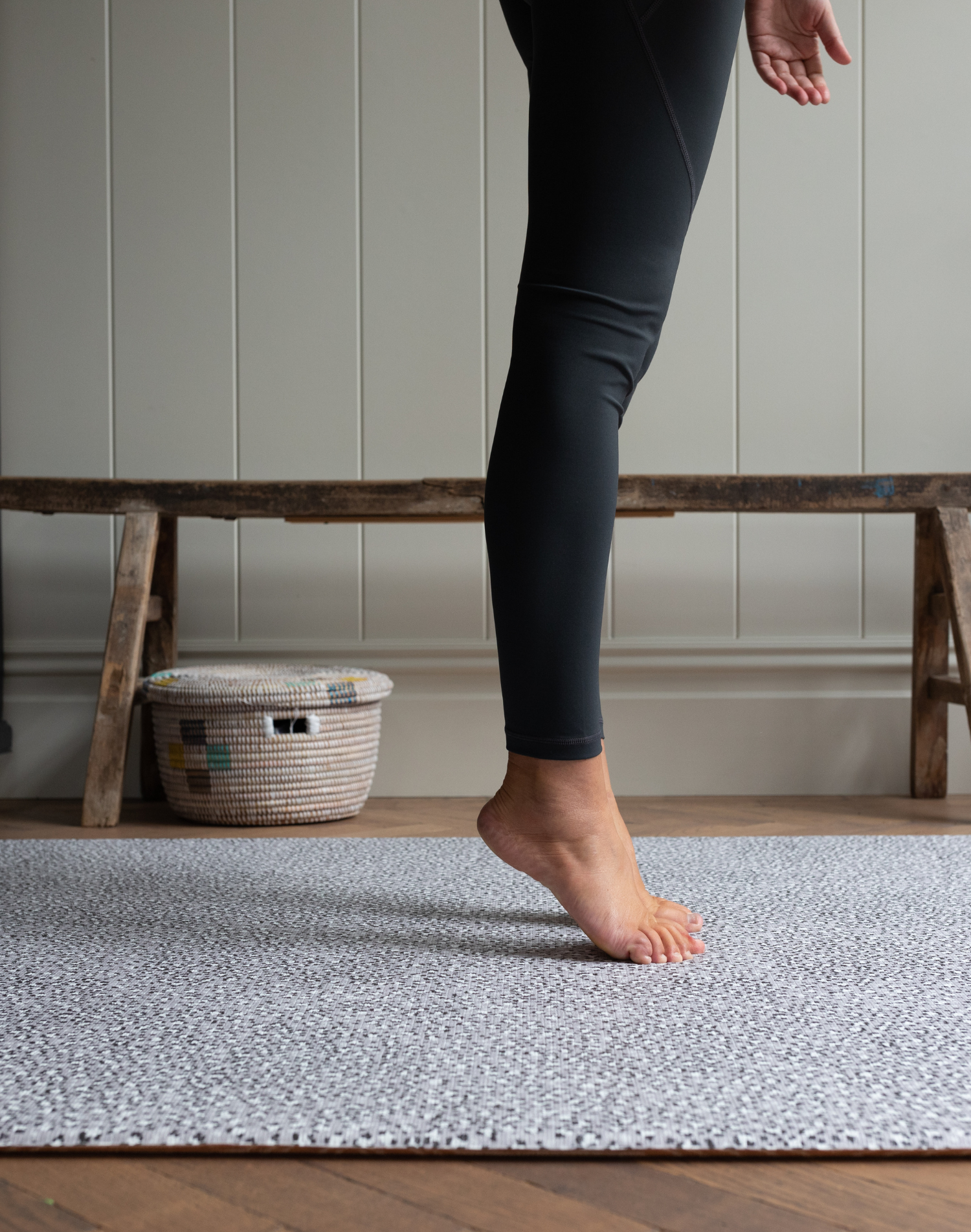 Legs are supported during exercise on the exercise mat by totter and tumble with grey leopard print design