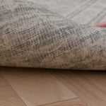 A video of a hand lifting up a rug-like extra large playmat. On the reverse we see a stylish grey patterned deign