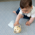Wipe clean baby playmat with baby sitting on it