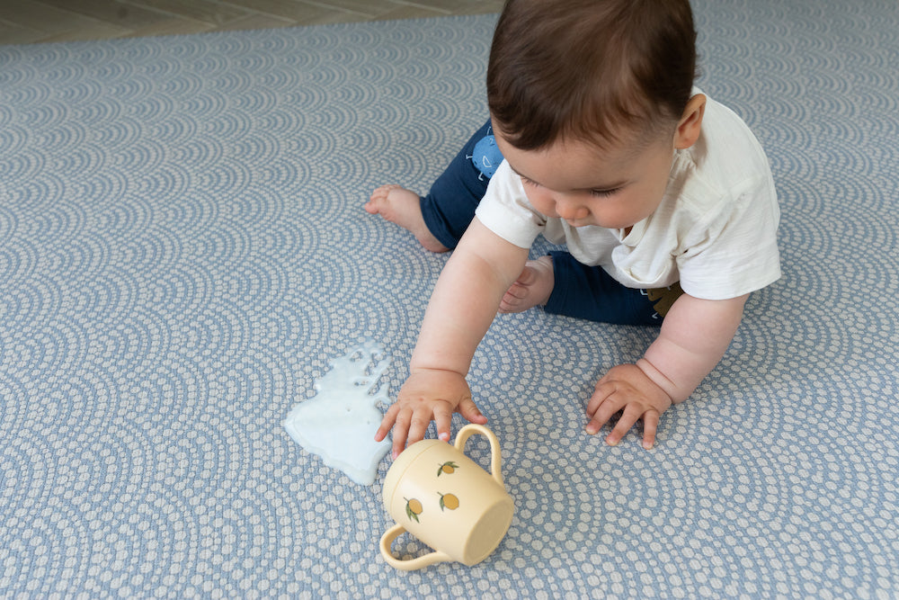 Wipe clean baby playmat with baby sitting on it