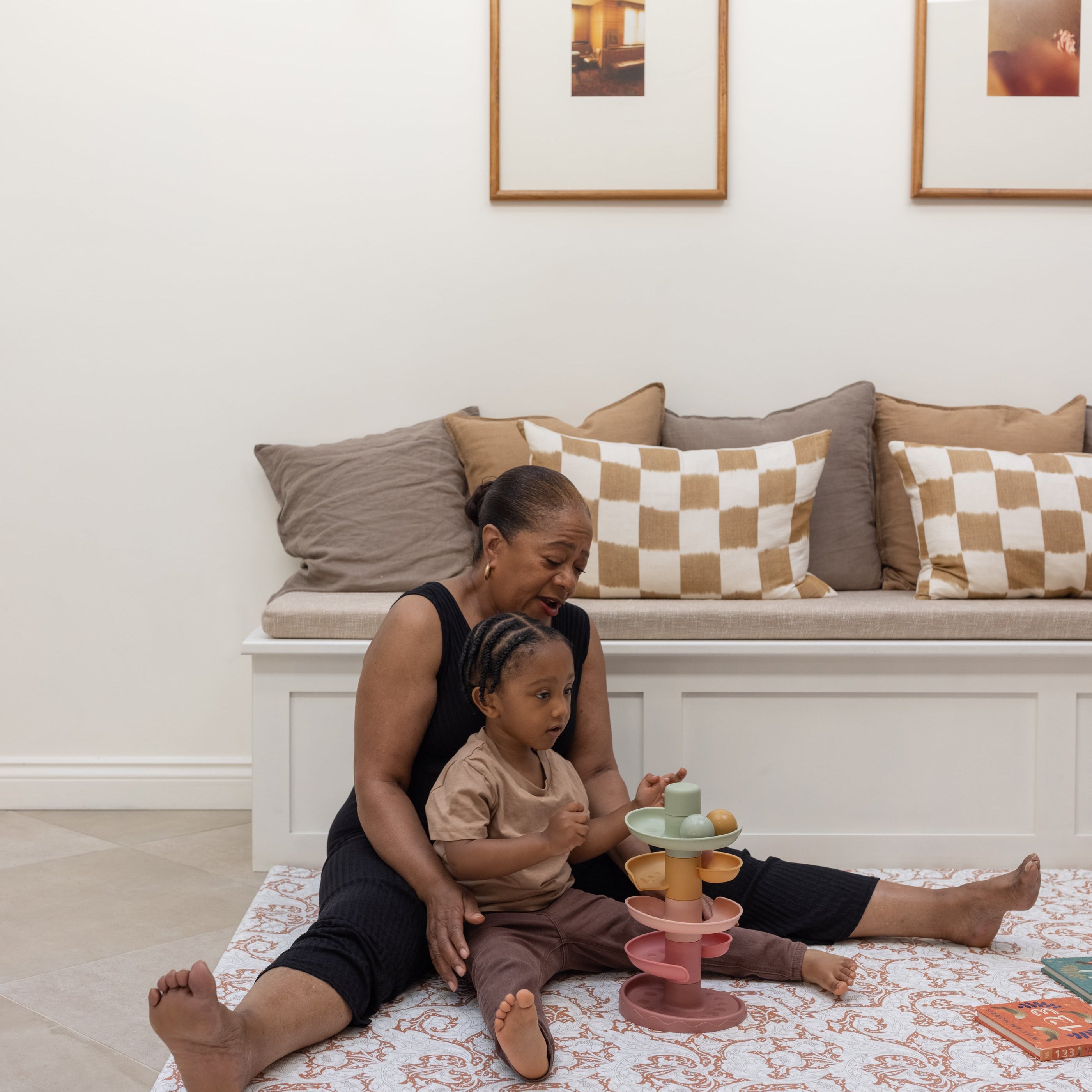 family playing on a soft supportive totter and tumble playmat