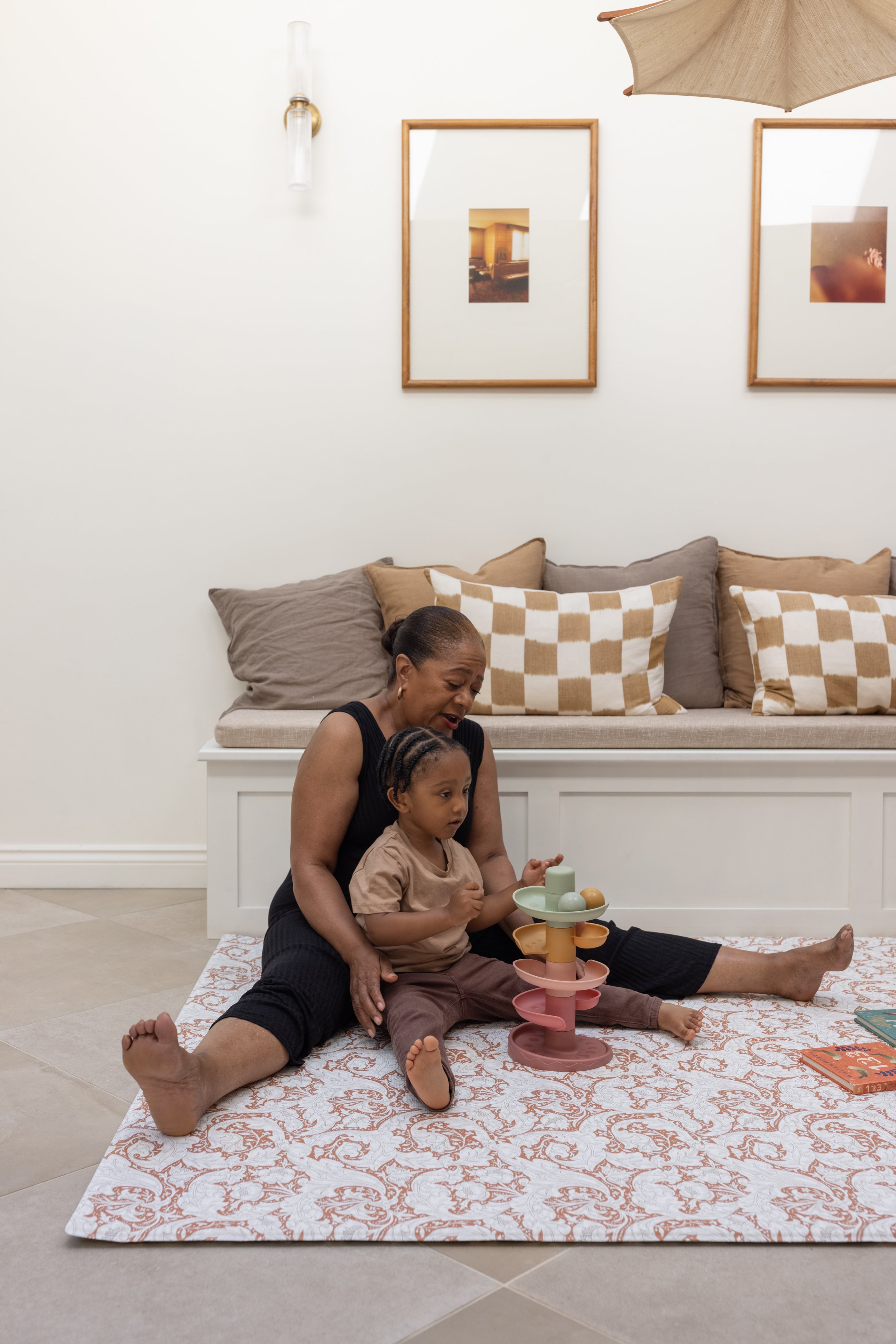 family playing on a soft supportive totter and tumble playmat