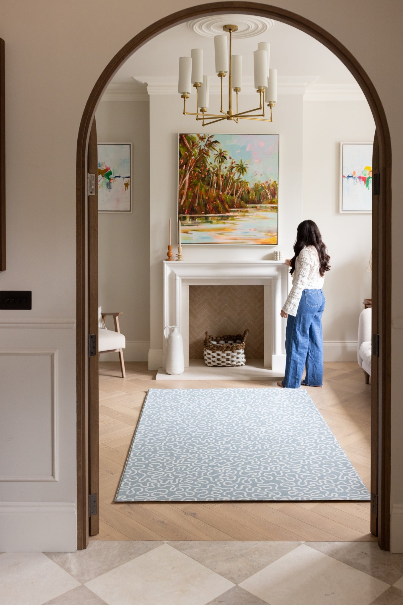 A sophisticated living room interior featuring a large soft blue rug-like playmat